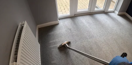 Carpet cleaning wand cleaning gray carpet in a Mandan home