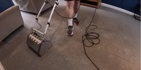 Powered carpet cleaning machine cleaning brown carpet in South Bismarck